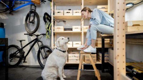 A woman and her dog in a garage