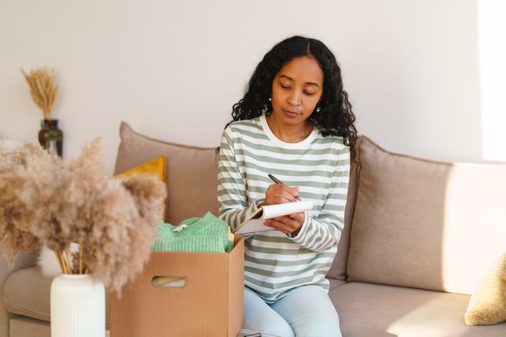 A woman making a checklist for her move.