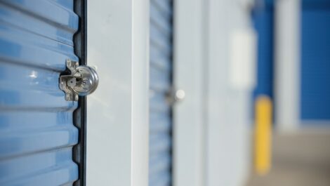 A blue storage unit with a round disc lock.