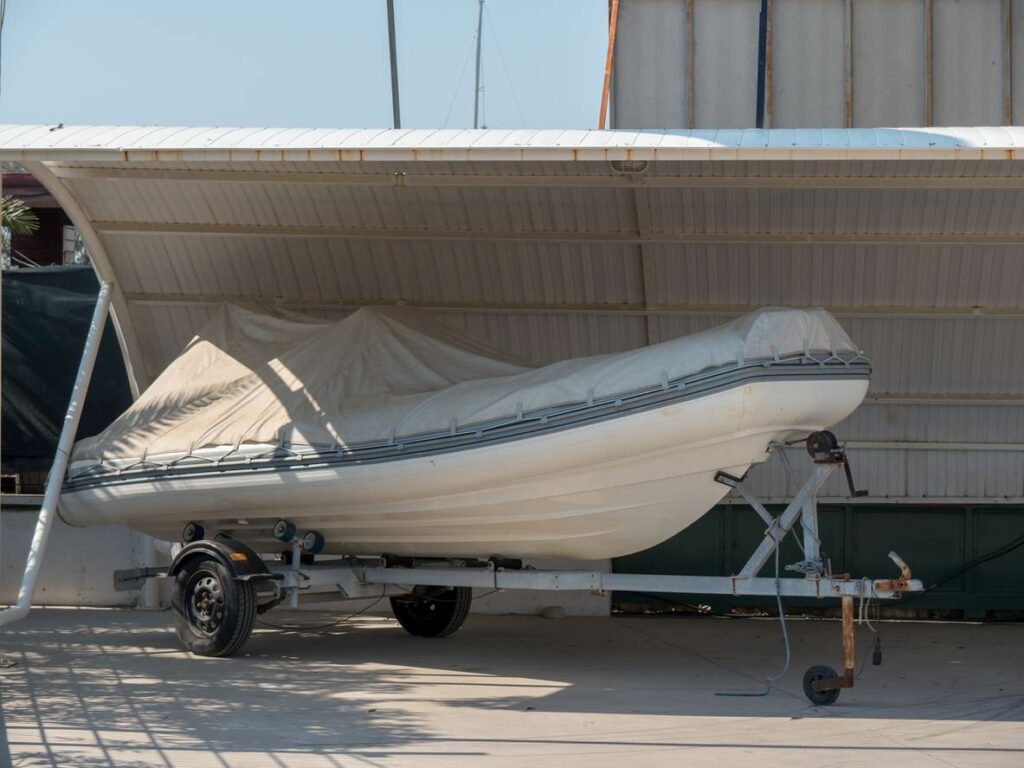 A boat stored underneath a canopy