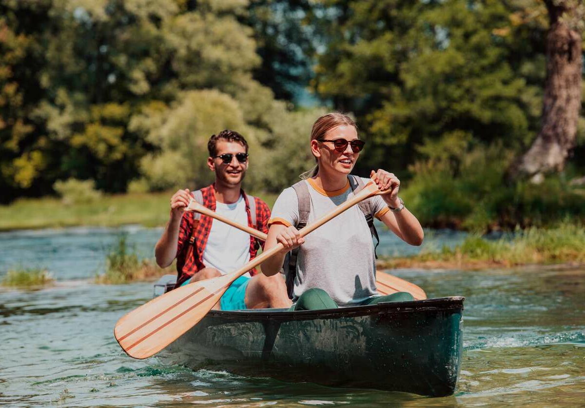 A couple sharing a kayak on the water