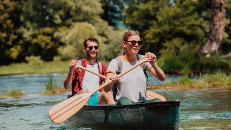 A couple sharing a kayak on the water