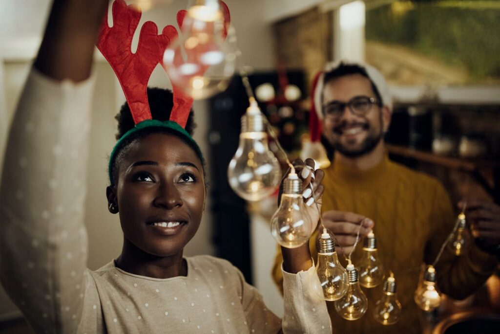 Young happy couple decorating their house for Christmas