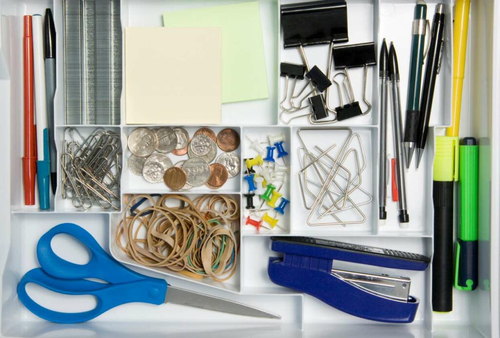An office drawer kept tidy with a desk organizer.