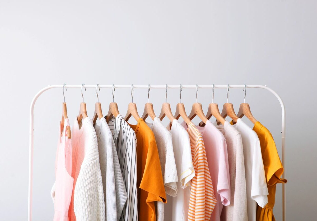 Fashion clothes on a rack in a light background indoors