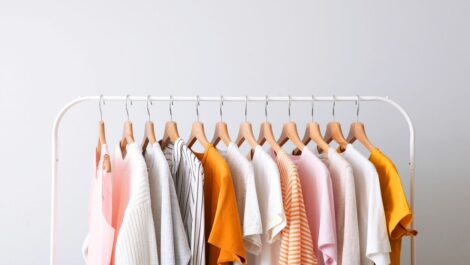 Fashion clothes on a rack in a light background indoors