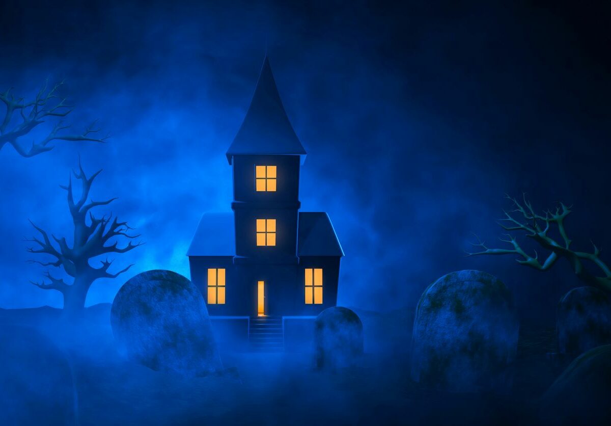 Blue concept image of a haunted house with a graveyard in the foreground.