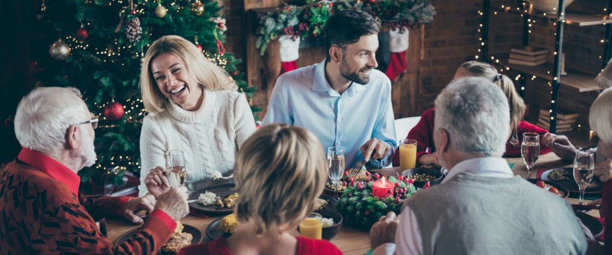 A happy family sits together during a Christmas family gathering.