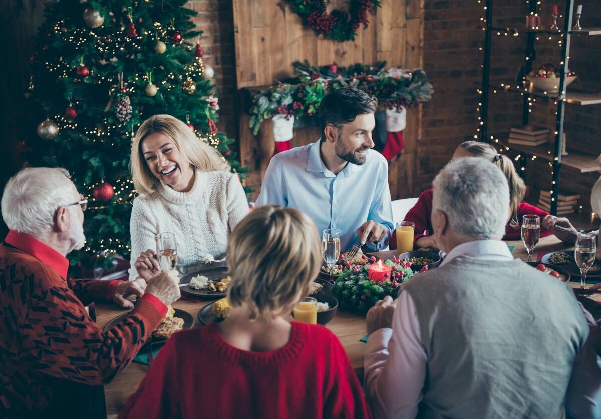 A happy family sits together during a Christmas family gathering.