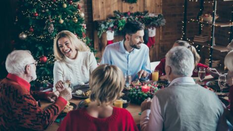 A happy family sits together during a Christmas family gathering.