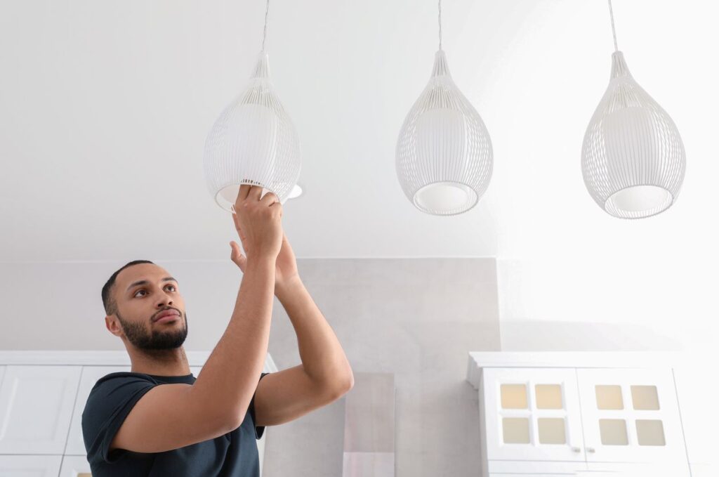 A man replacing his light fixtures